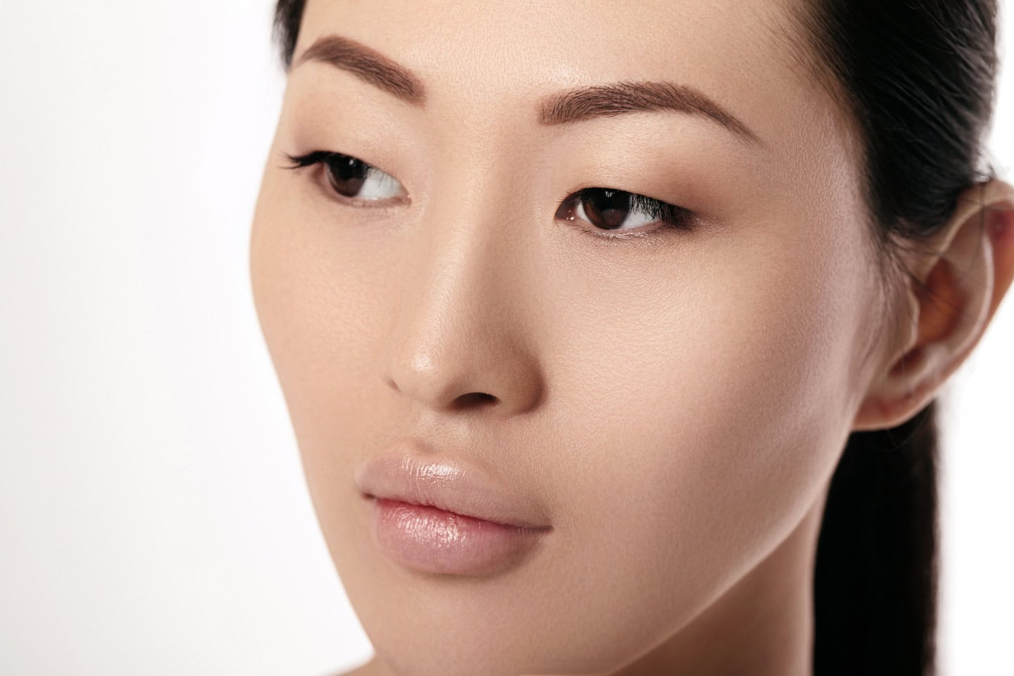 A close-up of a serene woman with smooth, glowing skin and natural facial contours, exemplifying the benefits of following the dermal fillers recovery guide at Serenity MedSpa for achieving refreshed and youthful results.