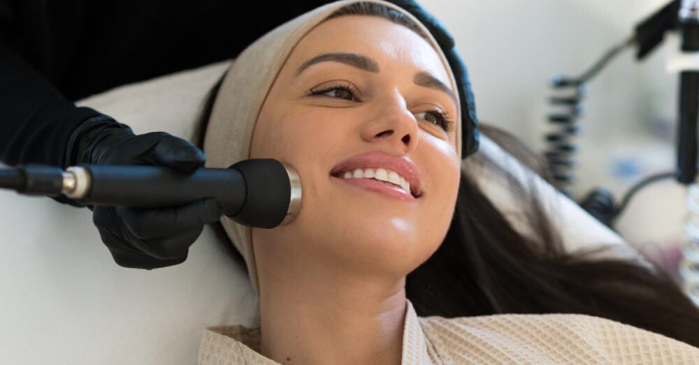 Woman smiling with glowing, refreshed skin